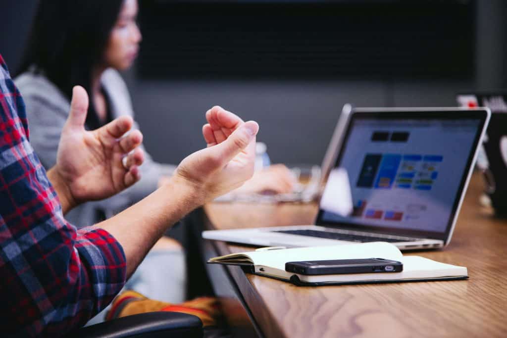 Hands of a man explaining a report during a business meeting