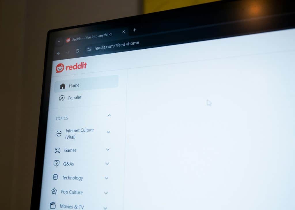 A laptop's screen showing Reddit's homepage