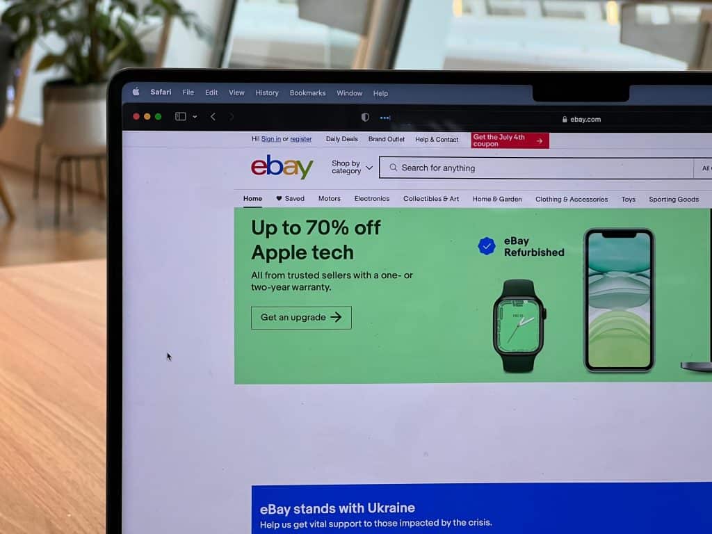 A laptop screen showing eBay's homepage
