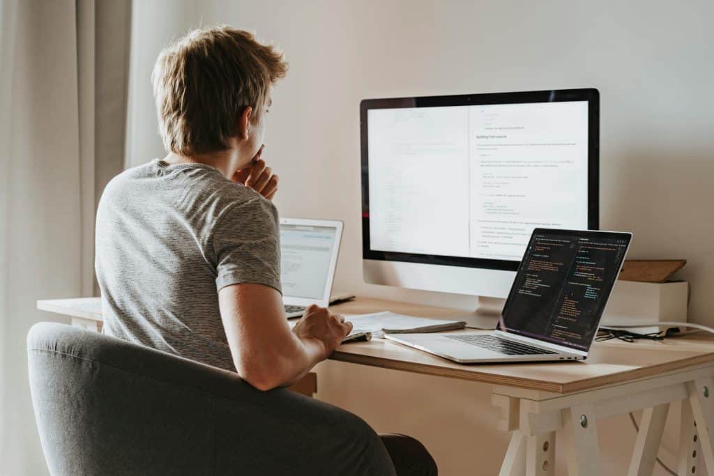 Man sitting and working in front of a desktop setup