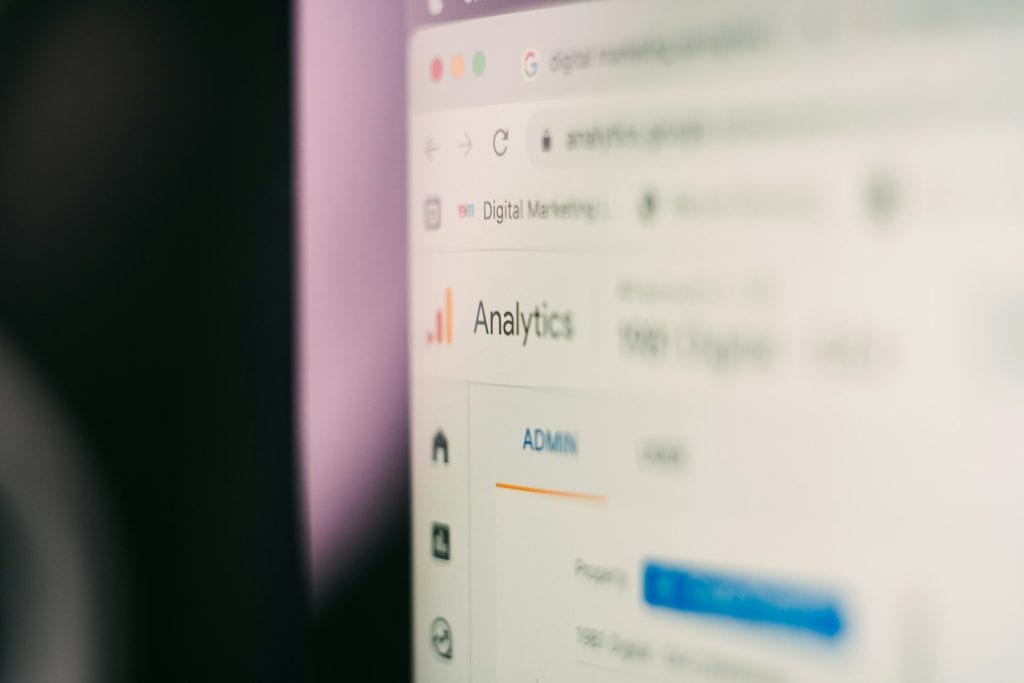 Close-up of a computer screen showing a blurred Google Analytics dashboard with the word Analytics in focus