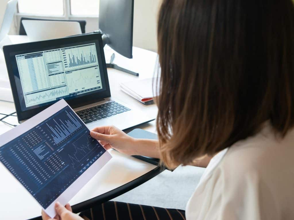 Woman analyzing data charts on a laptop